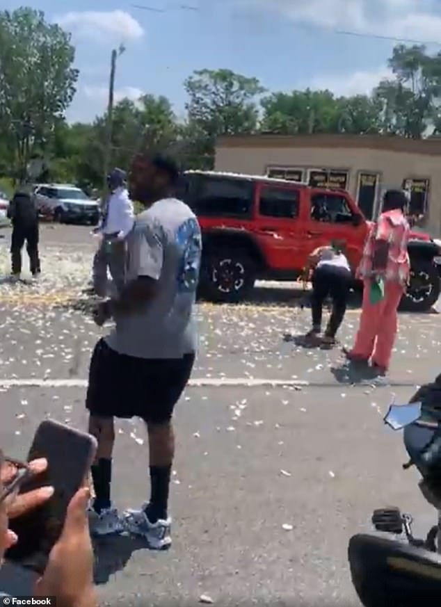 Footage shows petals and dollar bills fluttering down from the chopper