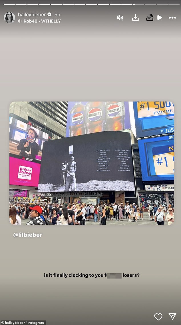 Hailey appeared to take aim at the 'losers' who have speculated about their marriage as she re-posted a photo of Justin's massive Swag billboard in NYC 's Times Square