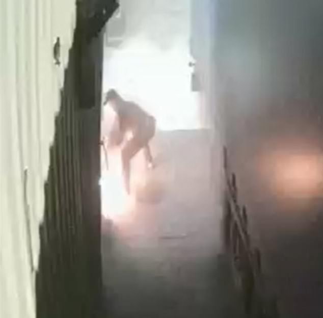 The attack was caught on CCTV as the gang ran away. A fire can be seen in the background