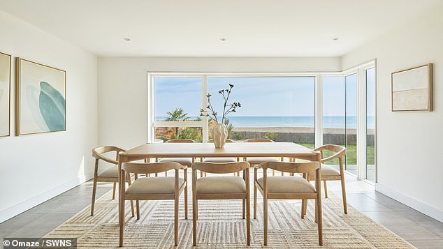 The main residence provides a spacious layout with three reception rooms, including a first floor living room with an integrated bar area offering breathtaking sea views