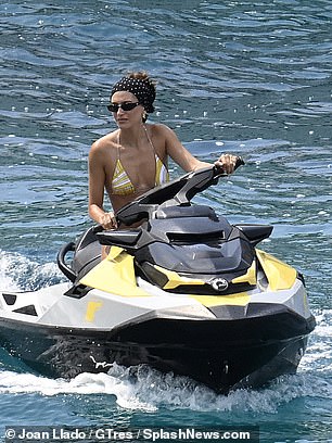The star sped around on a jet ski as for her latest shoot for her lip gloss line for her billion dollar brand Rhode