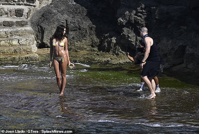 Hailey posed in the shallow water near the shore as she let her hair fall loose