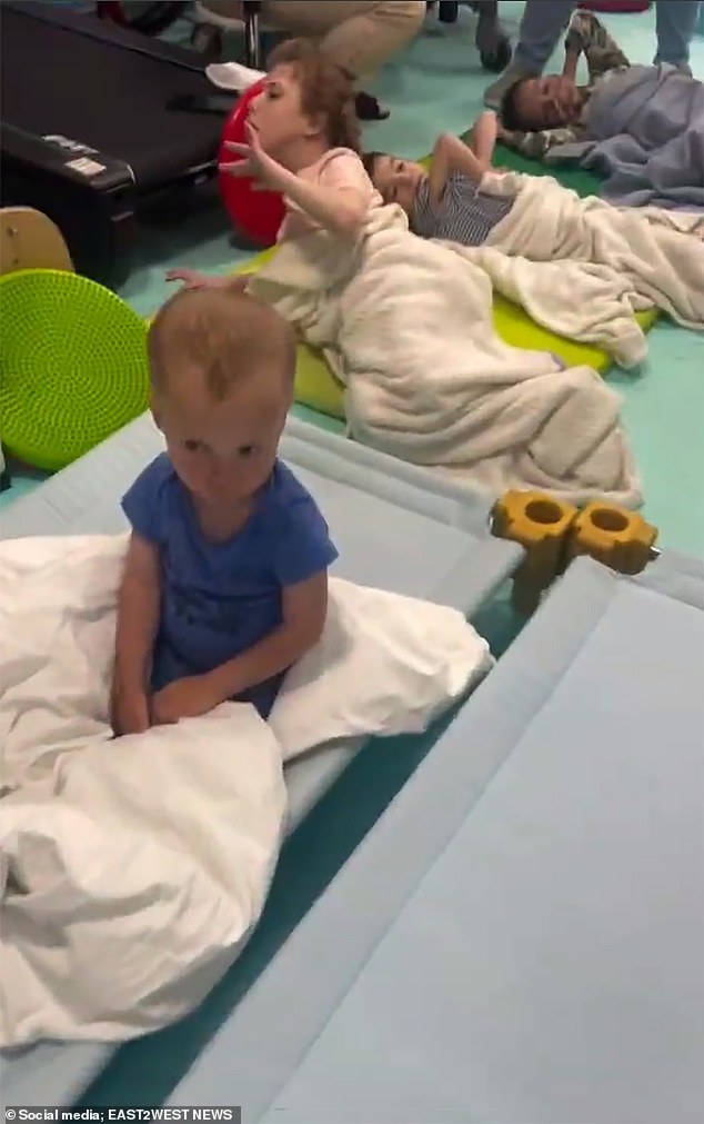 The children were seen on mats on the floor after being removed from their beds due to Putin bombing