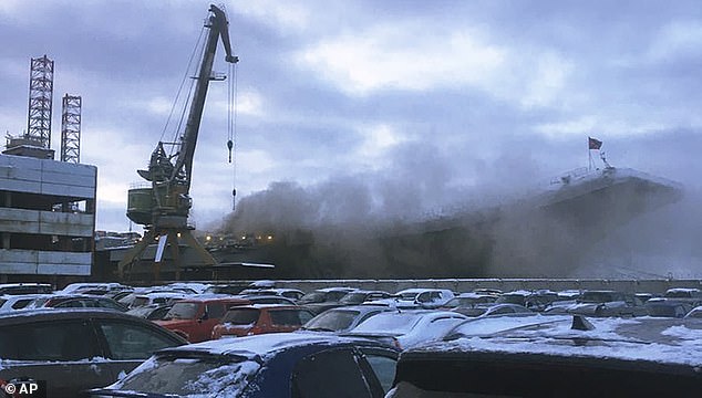 Pictured: Smoke billows from the Admiral Kuznetsov carrier during a fire in Murmansk, Russia, Thursday, December 12, 2019