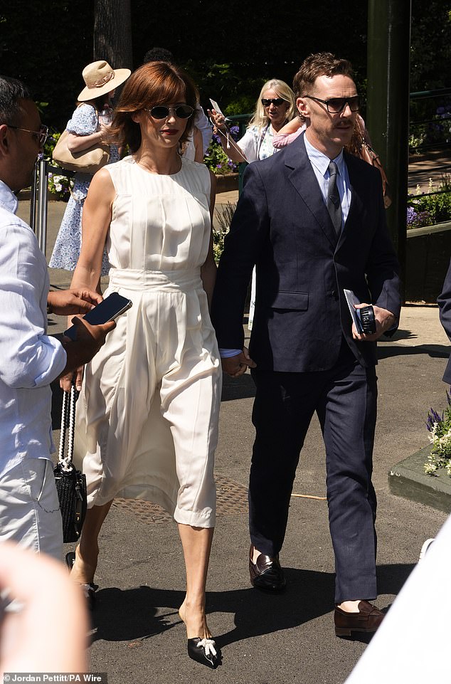 Benedict Cumberbatch sported a moustache and navy suit as he held hands with his wife Sophie Hunter