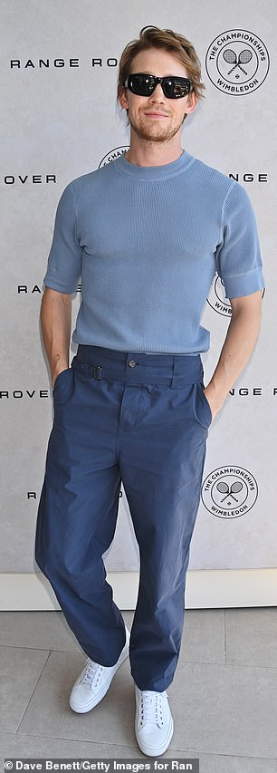 Keeping it casual Joe opted for alight blue T-shirt, darker blue trousers, white trainers and shades