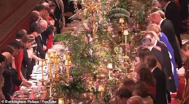 William quickly took his designated seat as the others continued standing, with the Prince looking side-to-side seemingly to check if anyone else was sitting