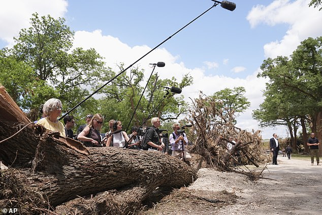 White House Chief of Staff Susie Wiles, left, and members of the media watch as President Donald Trump and first lady Melania Trump are briefed on flood damage