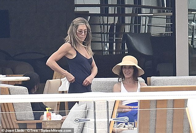 Aniston showed off her toned arms as she chatted with Jason Bateman's wife Amanda Anka