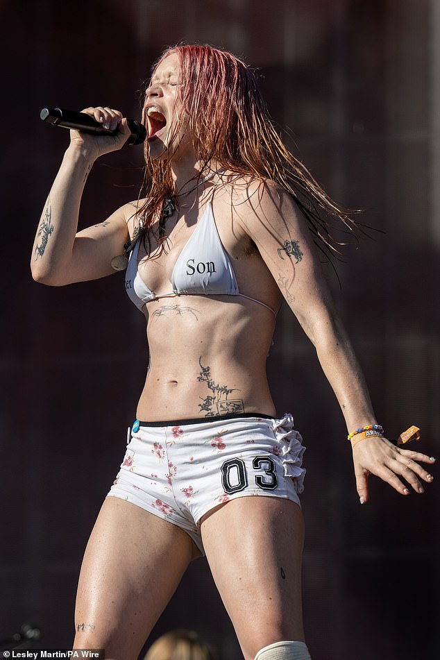 On a day where temperatures soared to 30C in the United Kingdom, the group's lead vocalist dressed down in a white bikini and coordinated hot pants for the performance