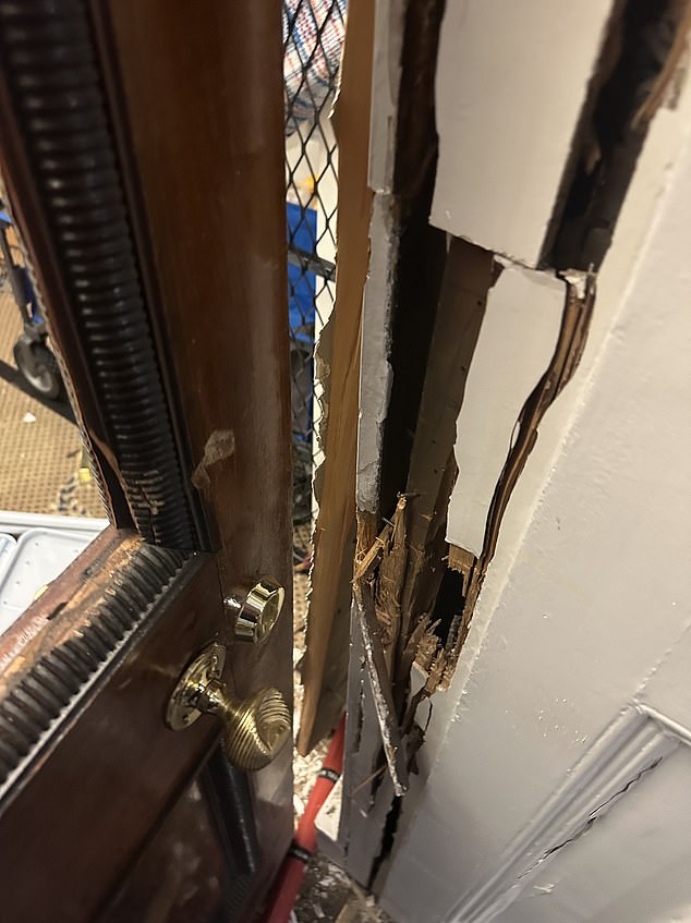 Pictured: Damaged to the door at the luxury handbag showroom where the £1.9m raid took place