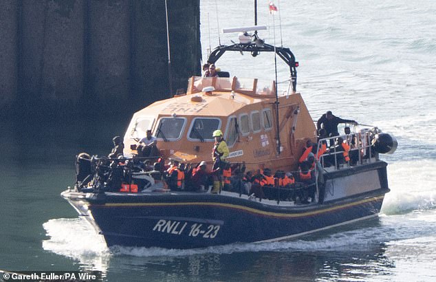 A group of people thought to be migrants are brought in to Dover, Kent, onboard an RNLI Lifeboat following a small boat incident in the Channel on July 11