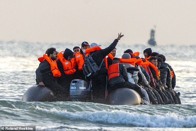 A migrant small boat passes the beech at Gravelines, France on July 10