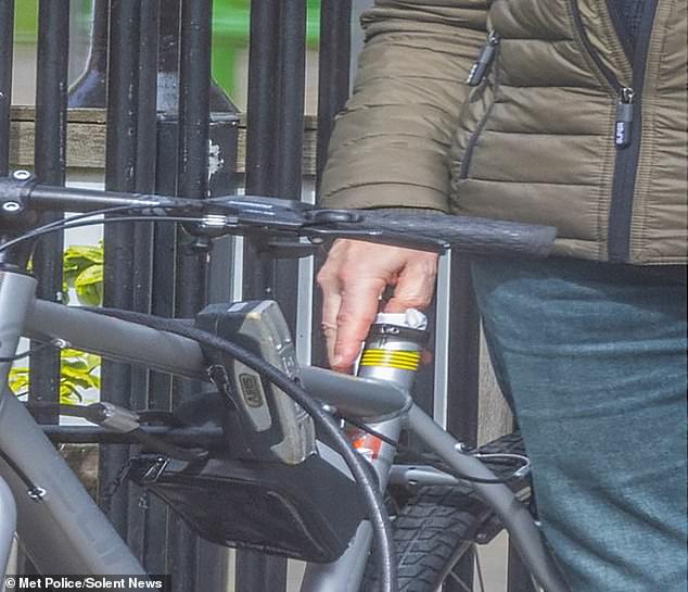 Phillips can be seen allegedly dropping off the USB stick containing the information into the hollow frame of a bicycle
