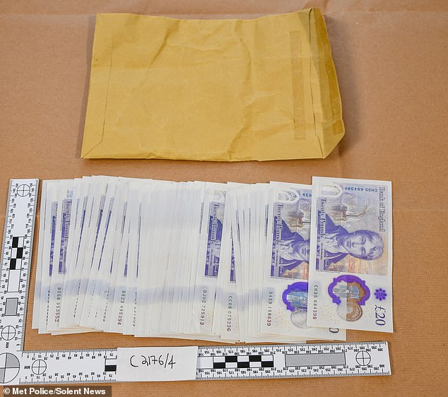 The cash and envelope full of wenty pound notes in Howard Philips' possession