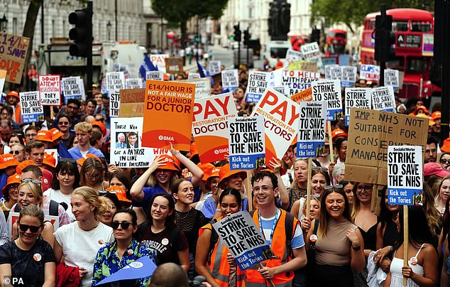 Thousands of medics demanding pay hikes of up to 29 per cent will walk out from July 25 to July 30. Pictured: Resident doctors during a rally outside Downing St at a previous strike in August 2023