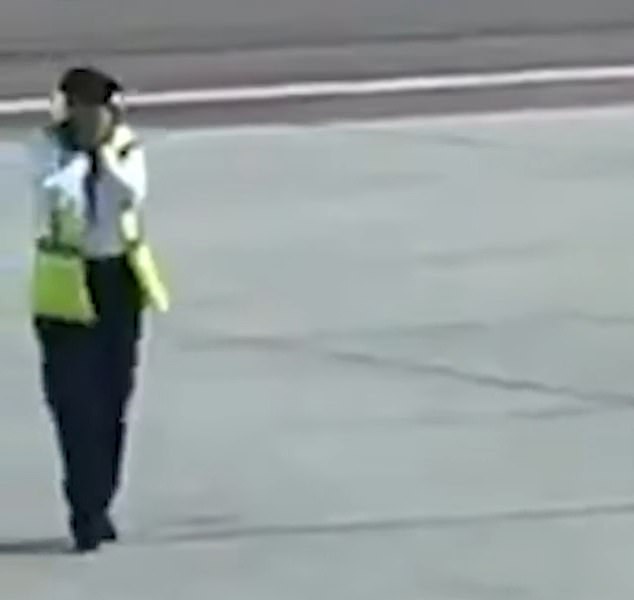 The man's body fell lifeless to the floor as one airport worker was seen holding her hands to her face in shock