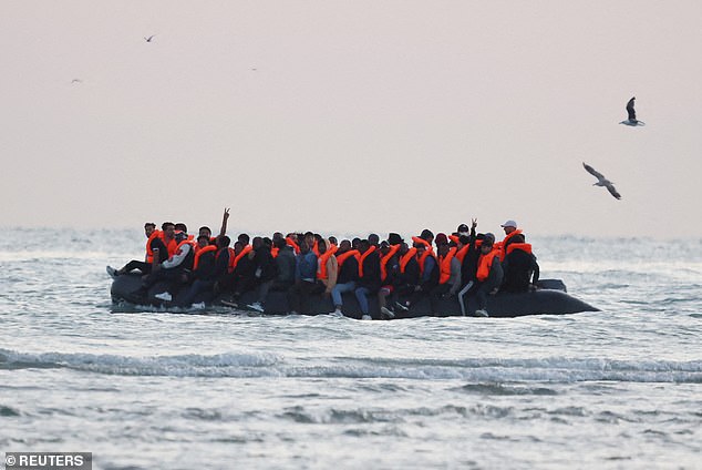 The new scheme was condemned by campaigners, who said they would support court cases brought by small-boat arrivals chosen to be sent back to France. Pictured: Migrants sit on an inflatable dinghy as it sails along the coastline near Gravelines, France, on Thursday