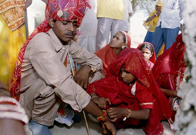 Amlee, a five-year old bride, with her husband, Ashok, 15, during their marriage ritual in Indian desert village Srirampur of northwestern state of Rajasthan on May 14, 1994