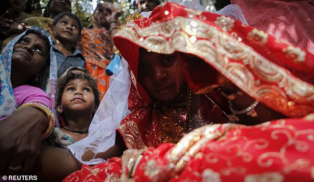 Child bride Krishna, 11, sits during a marriage ceremony at her husband's home in a village near Kota, located in the northwestern state of Rajasthan, in this May 16, 2010