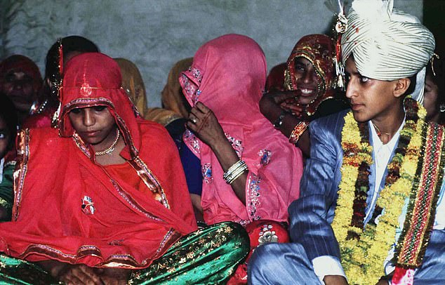 Lalaram, 13, (R) looks at his bride, 11, (L, unidentified) during an illegal child wedding ceremony near Jaipur in the northwestern state of Rajasthan