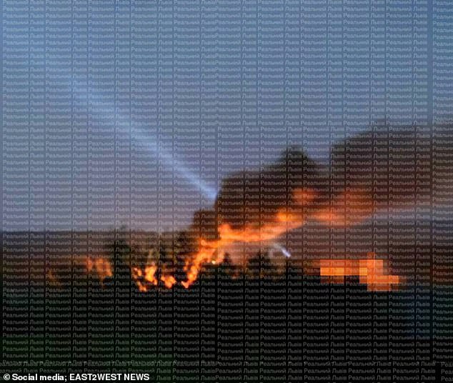 Acrid smoke could be seen lingering over the city following the strikes and rescue workers were pictured inspecting burnt cars and rubble. This picture shows aftermath of an attack in Lviv