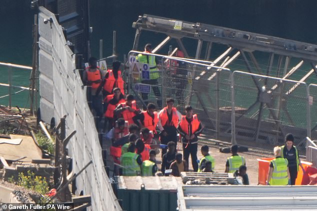 There is also no guarantee that after being stopped on their journey that migrants will not try again. Pictured: A group of people thought to be migrants are brought to a Border Force compound in Kent this morning