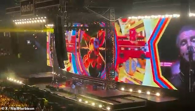 Buttons' face was projected in front of a sold-out 80,000 strong crowd in their home city of Manchester for night one of their five sold out shows at Heaton Park on Friday