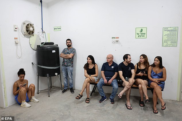 Meanwhile, in Israel, purpose-built shelters for civilians are dotted across the country (pictured are beach-goers who sought safety in a bunker in Tel Aviv on June 23)