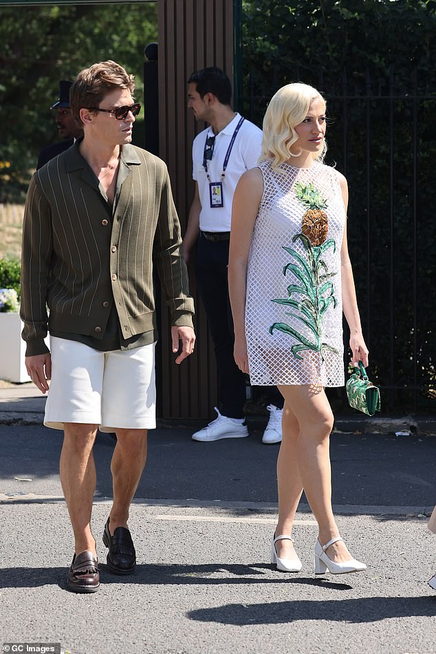 The singer completed the look with a simple pair of white heels as she was joined by her husband Oliver Cheshire who opted for cream shorts and a brown striped shirt