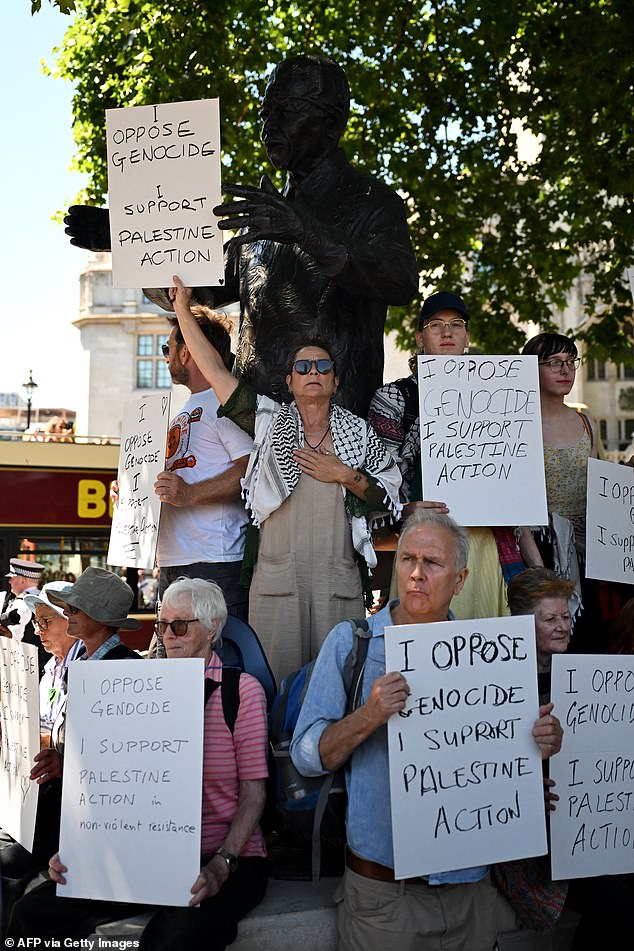 the small group of protesters sat at the steps of the Mahatma Gandhi statue shortly after 1pm in a silent protest