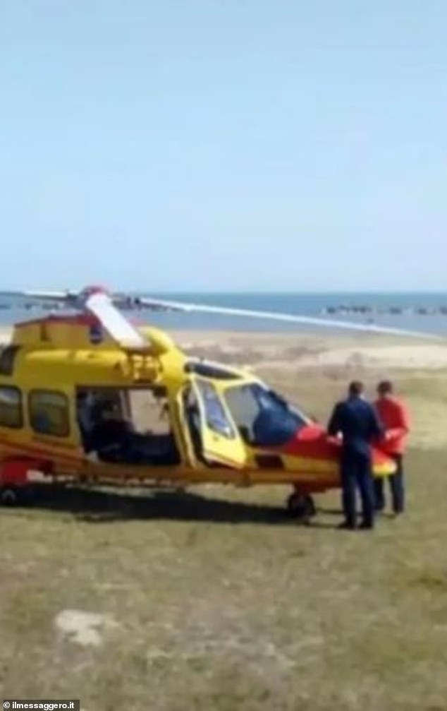 Riccardo had been playing in the sand, carving out a tunnel that he intended to crawl through from one side to the other. Pictured: Emergency services at the scene