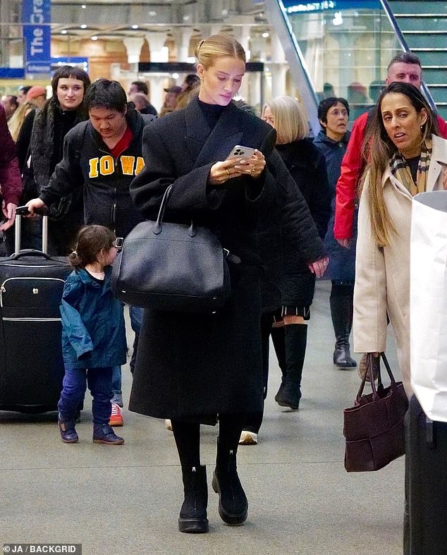 After hitting the runway during Paris Fashion Week, Rosie Huntington-Whiteley kept a low key figure as she returned to London on the Eurostar