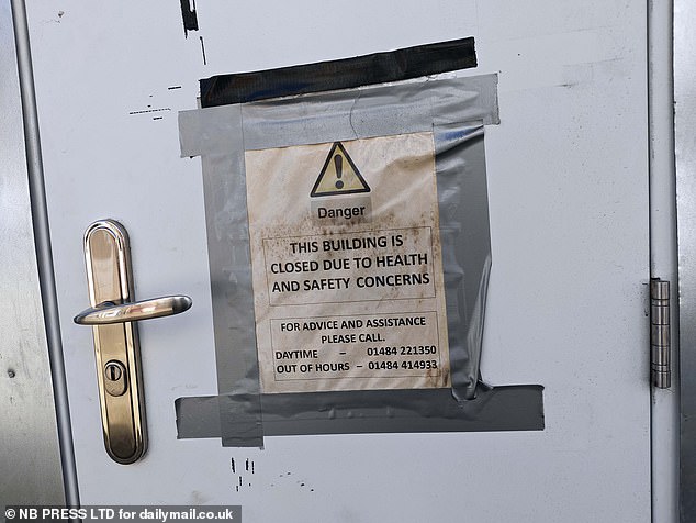 A sign on a front door of one building says it is closed 'due to health and safety concerns'
