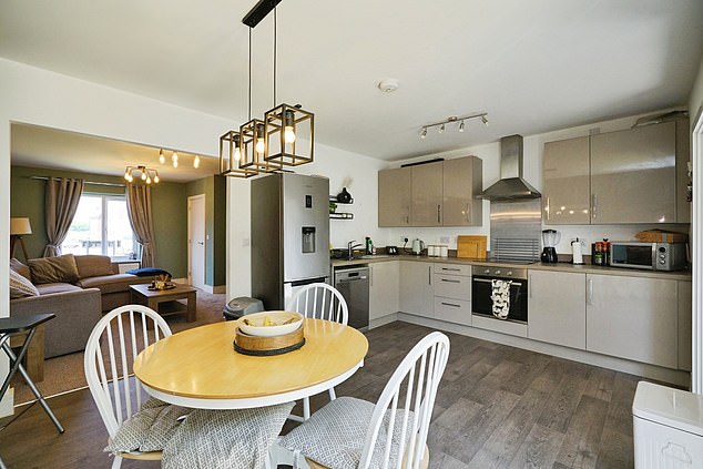 The property's centrepiece is its sleek contemporary kitchen and dining area