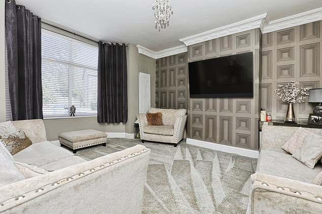 The property includes a front living room with a bay window and a rear dining room that connects to the kitchen