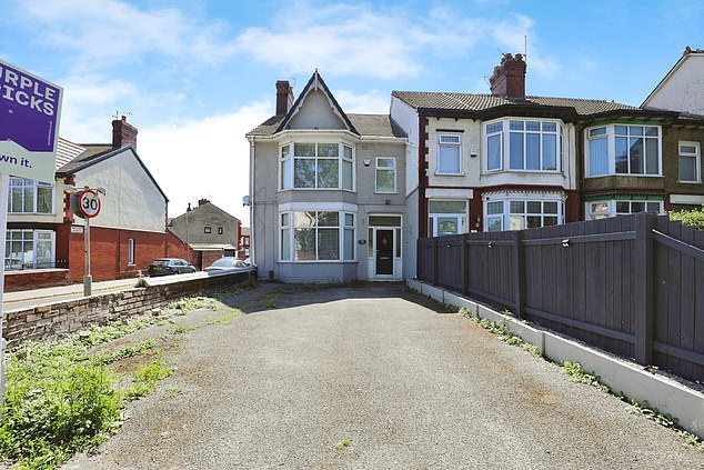 This four-bed end-terrace house on Moss Lane in Liverpool has three floors and driveway parking