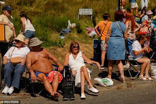 Amber heat health alerts are in place for the Midlands and the south and east of England until 9am on Monday. Pictured: Spectators at the Twelfth of July parade in Belfast on Saturday
