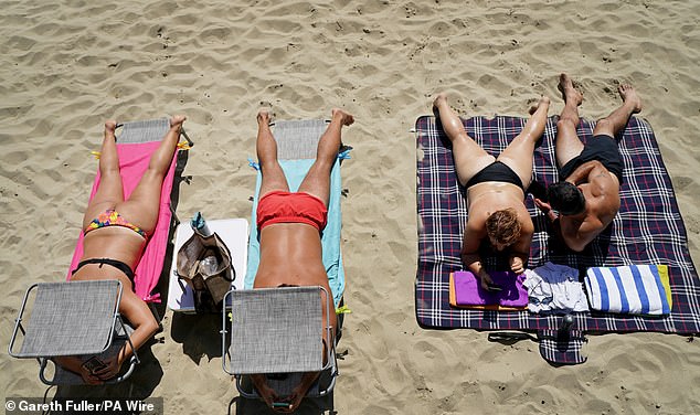 Temperatures reached 34.7C at Astwood Bank, near Worcester, on Friday, the Met Office said, with similar or even higher temperatures having been expected today. Pictured: Sunny Sands beach in Folkestone, Kent, on Friday