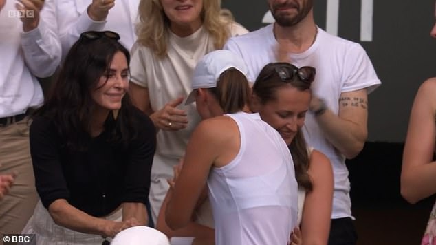As she sat front row, tennis champion Iga approached the actress to celebrate her win with a hug, as Centre Court applauded her win