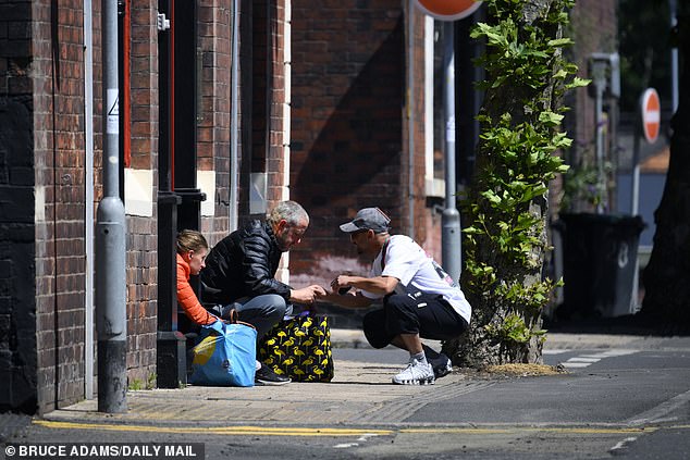 Residents told MailOnline of how the town, which dominated the Pottery industry, went into decline after firms moved production to Indonesia. Pictured, men sat on the side of the road