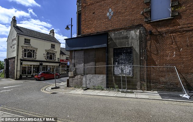 Another row of boarded up shops on the high road. The area was once a bustling market town