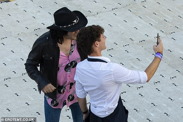 The pair walked side-by-side as they headed to the main stage, with Noel stopping for photos with fans as he strolled through the park