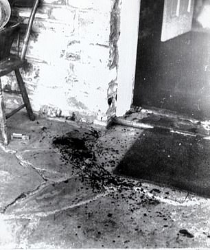A blood splatter is seen on the floor next to a chair inside Cielo Drive