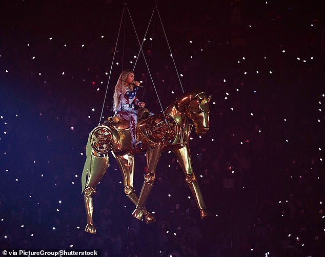 She notably sits on the prop as it soars through the air while belting out her country track 16 Carriages