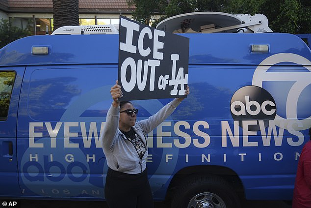 A protester in Los Angeles makes clears her opposition to Operation Excalibur