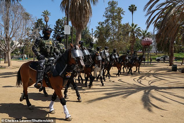 Ninety National Guard soldiers in combat gear, backed by a line of horsemen (pictured) and dozens of heavily armed federal immigration agents, descended on MacArthur Park in LA last week in an intimidating show of force
