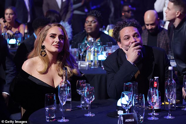 The singer with Lucy's husband, Jonathan Dickins, before accepting her award during The BRIT Awards 2022 at The O2 Arena on February