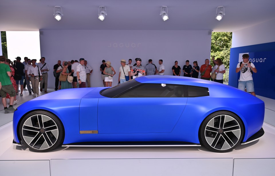 Side view of a blue Jaguar Type 00 concept car on display.