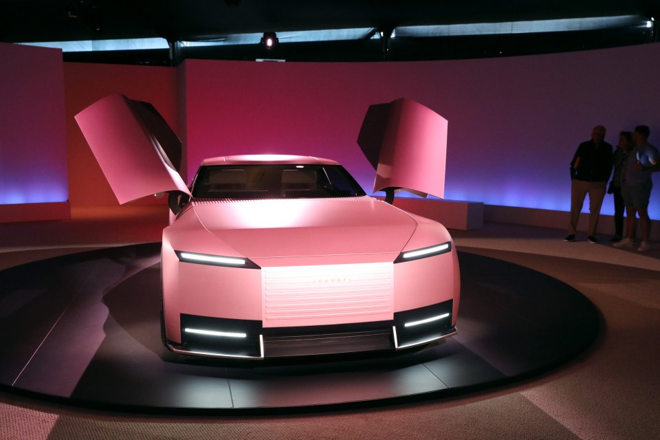 Pink Jaguar Type 00 vehicle on display.